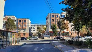 an empty street in a city with tall buildings at M Suite - close to the beach in Mangalia