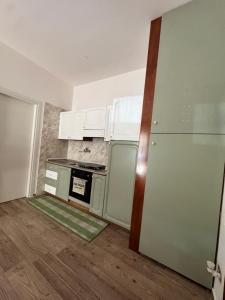 an empty kitchen with white cabinets and a stove at La casetta di Nino in Termoli