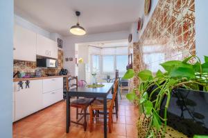 a kitchen and dining room with a table and plants at See view Mignon de la Ria Formosa in Faro