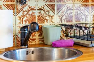 a kitchen sink with a faucet and a sponge at See view Mignon de la Ria Formosa in Faro +83 photos