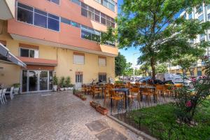 a restaurant with tables and chairs in front of a building at See view Mignon de la Ria Formosa in Faro