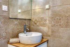 a bathroom with a sink and a mirror at Mas Des Jeux - Gîte Grenache in Saint-Laurent-dʼAigouze +20 photos