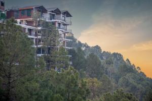 a building on the side of a mountain at Dream Haven Kasauli in Kasauli