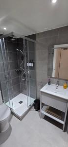a bathroom with a shower and a toilet and a sink at Modern Executive Studio in Gibraltar +4 photos
