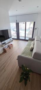 a living room with a couch and a flat screen tv at Modern Executive Studio in Gibraltar