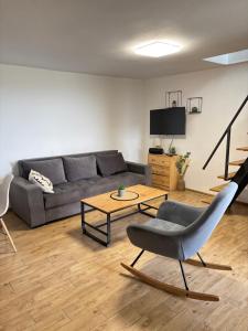 a living room with a couch and a table at Family House with private pool in Krčedin
