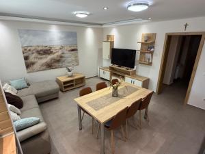 a living room with a table and a couch at Pater Apartman in Zalaegerszeg