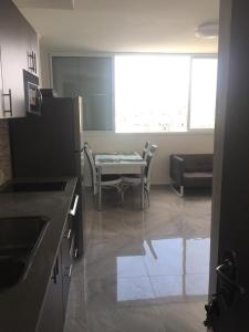 a kitchen with a table and chairs in a room at Dizengoff 24A in Netanya