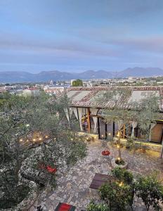 a building with a courtyard with trees and lights at Vila Shehi Guesthouse and Winery in Tirana