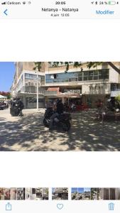 a person riding a motorcycle on a city street at Dizengoff 24A in Netanya