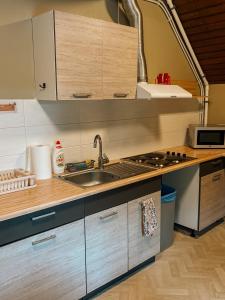 a kitchen with a sink and a stove at Pargi apartment 2 in Viljandi