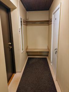 an empty hallway with a door and a rug at Pargi apartment 2 in Viljandi +1 photo
