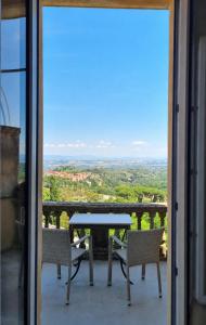 a table and chairs on a balcony with a view at Albergo Il Marzocco - Hotel dal 1860 in Montepulciano