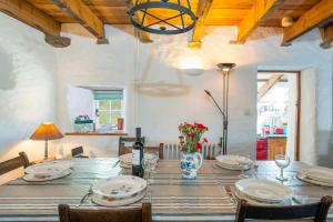 a dining room table with plates and flowers on it at Melin Abereiddy in Haverfordwest