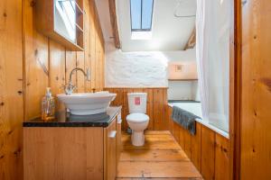 a small bathroom with a toilet and a sink at Melin Abereiddy in Haverfordwest +32 photos