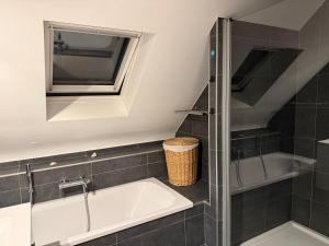 a bathroom with a tub and a sink at Martinique in Chaumont-Gistoux
