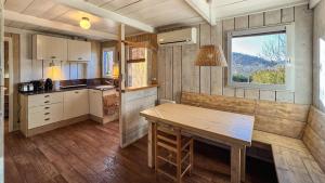a kitchen with a wooden table and a window at Cabaña Le Sapin in Osséja +16 photos