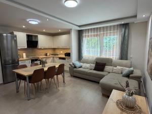 a living room with a couch and a table at Pater Apartman in Zalaegerszeg