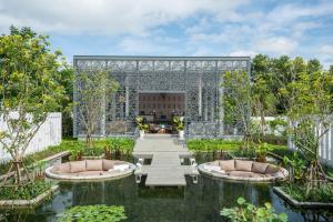 a garden with two ponds and a pavilion at Meliá Phuket Mai Khao in Mai Khao Beach