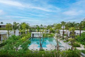an aerial view of a resort pool with umbrellas at Meliá Phuket Mai Khao in Mai Khao Beach