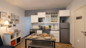 a small kitchen with a table and a refrigerator at Notre bout du monde t1bis brest centre terrasse in Brest