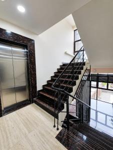 a staircase in a house with a brick wall at Hotel Pune Grand in Pune