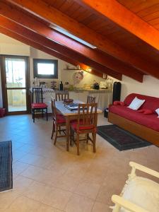 a living room with a table and chairs and a couch at B&B Su Canistreddu in Alghero