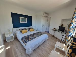 a bedroom with a large bed with a blue wall at Montèze Paradis in Saint-Christol-lès-Alès +44 photos