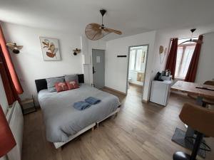 a bedroom with a bed with two pillows on it at ecuires 1 in Écuires +3 photos