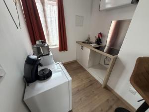 a small white kitchen with a sink and a counter at ecuires 1 in Écuires