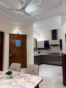 a kitchen with a table and chairs and a ceiling fan at CRAZZY HOME stay in Chandigarh Airport