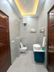 a bathroom with a toilet and a sink and a mirror at CRAZZY HOME stay in Chandigarh Airport +30 photos