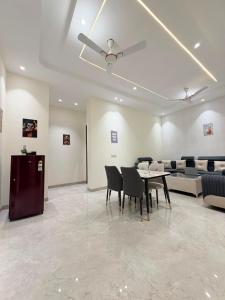 a dining room with a table and chairs and a ceiling at CRAZZY HOME stay in Chandigarh Airport