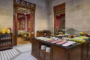 a buffet line with food on display in a restaurant at NH Collection Vigo in Vigo