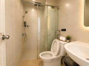 a bathroom with a shower and a toilet and a sink at Sleep & Go Capsule Hostel Bui Vien District 1 in Ho Chi Minh City +43 photos