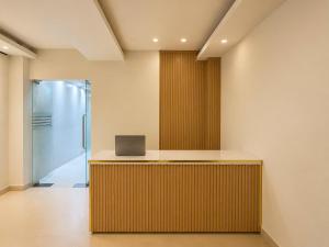 an office with a desk with a laptop on it at Sleep & Go Capsule Hostel Bui Vien District 1 in Ho Chi Minh City