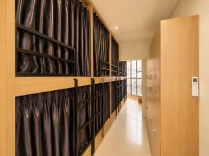 a hallway with black curtains on the wall at Sleep & Go Capsule Hostel Bui Vien District 1 in Ho Chi Minh City