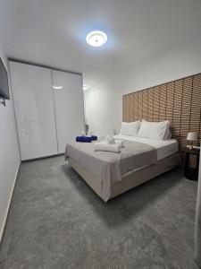 a bedroom with a large bed and a large screen at Divina Loft C Modern Loft with Shared Pool in Perivolia +12 photos