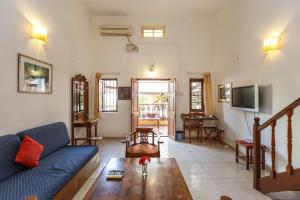 a living room with a couch and a table at Casa Cottage in Bangalore