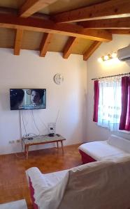 a bedroom with two beds and a tv on the wall at Jelena i Agi apartman Bibinje in Bibinje