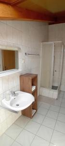 a white bathroom with a sink and a shower at Jelena i Agi apartman Bibinje in Bibinje +25 photos