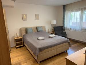 a bedroom with a bed with two towels on it at Pater Apartman in Zalaegerszeg