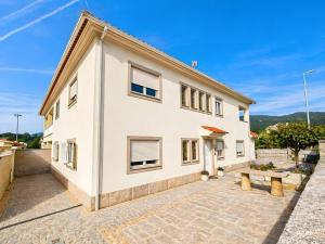 a white house with a bench in front of it at Caramulo Valley View in Campo de Besteiros