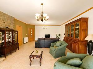 a living room with a couch and a table at Caramulo Valley View in Campo de Besteiros +21 photos