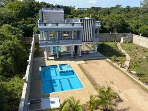 an aerial view of a house with a swimming pool at J&T Holme Villa in Galu