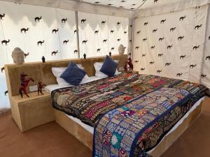 a bedroom with a bed in a tent with bats on the wall at Style Heritage Resort & Camp in Sām