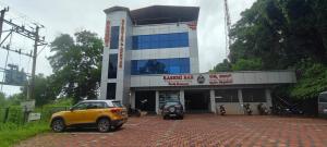 a building with a car parked in front of it at Shree Ganesh lodging in Bārkūr