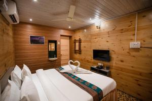 a bedroom with a bed with a towel on it at Giri Mandala The Mountain Vihar in Welhe