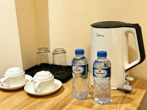 two bottles of water sitting on a wooden table at zhiyuanta hotel in Vientiane