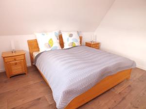 a bedroom with a large bed with two night stands at Komfort-Ferienwohnung gierskopp.pur in Olsberg